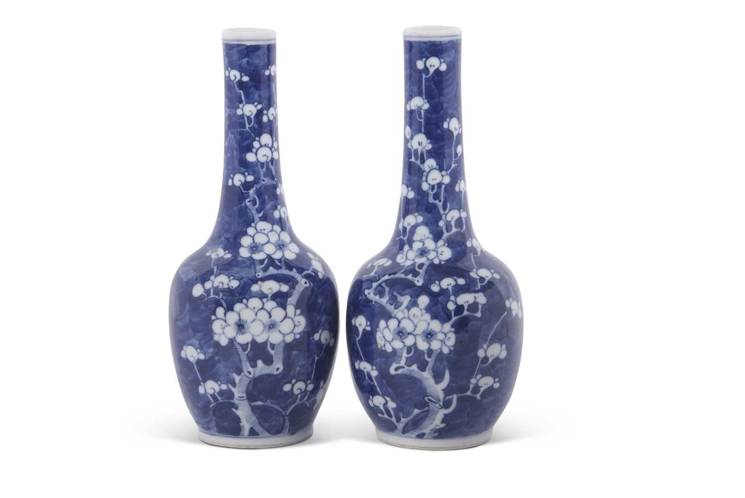 Pair of Chinese porcelain bottle vases, the blue ground decorated with prunus, 19th Century,