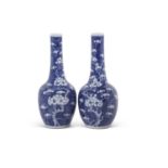Pair of Chinese porcelain bottle vases, the blue ground decorated with prunus, 19th Century,