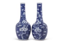 Pair of Chinese porcelain bottle vases, the blue ground decorated with prunus, 19th Century,