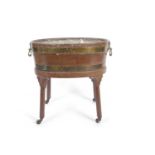 A 19th Century mahogany and brass bound oval wine cooler with metal liner and brass lions head