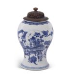 A Chinese porcelain vase of inverted baluster form with blue and white decoration and pierced wooden