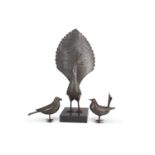 An Indian steel model of a stylised peacock, 45cm high together with two accompanying small model