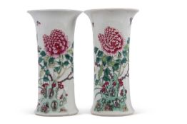 A pair of Chinese porcelain cylindrical shaped vases decorated in famille rose/vert with flowering