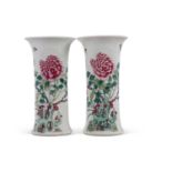 A pair of Chinese porcelain cylindrical shaped vases decorated in famille rose/vert with flowering