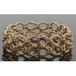 Fancy link bracelet, comprosed of two rows of hollow oval textured links with stud and hoop joins,