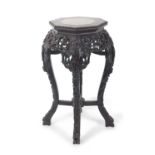 A Chinese hardwood and marble inset plant stand with octagonal top over a pierced frize and four