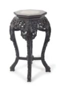A Chinese hardwood and marble inset plant stand with octagonal top over a pierced frize and four