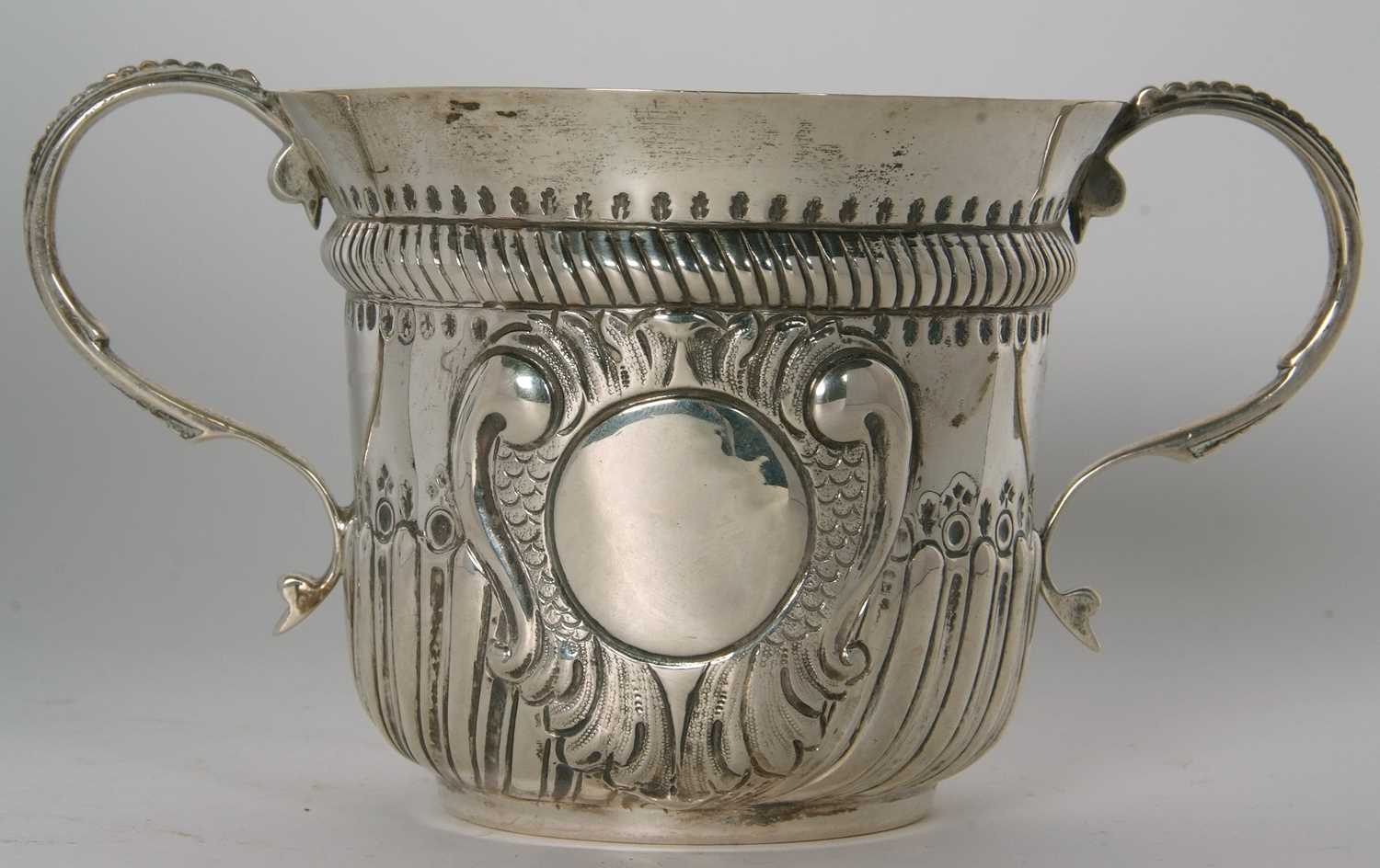 An early 20th Century copy of a George I loving cup, having two beaded scrolled handles, wrythen - Image 30 of 36