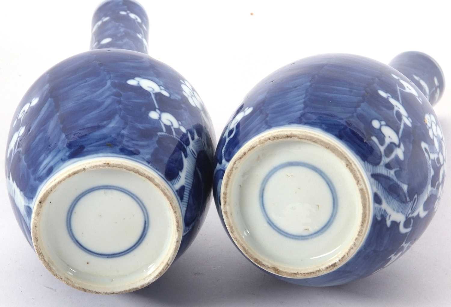 Pair of Chinese porcelain bottle vases, the blue ground decorated with prunus, 19th Century, - Image 4 of 4