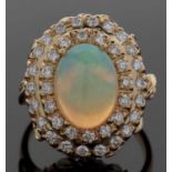 18ct opal and diamond ring, the central oval opal cabochon, approx. 13.1 x 9.8 x 6.1mm, surrounded