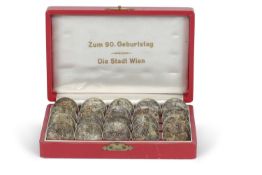 A boxed collection of Austrian 25 Schilling silver coins dated 1967. The case stamped to inside of