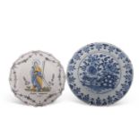 Two 18th Century Dutch delft plates, one with a blue and white floral design the other with a