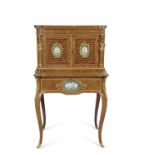 A French walnut porcelain and ormolu desk with two panelled doors to the top over a base with single