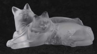 Pair of Lalique reclining cats in clear and frosted glass, etch mark to base, 15cm long