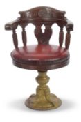 A Late 19th Century hardwood and cast base bow back ships Captains chair with red leather