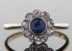Edwardian 18ct sapphire and diamond ring, the central round sapphire, collet mounted and