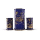 A garniture of Cauldon early 20th Century vases of faceted shape with gilt chinoiserie design