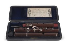 A 19th Century flute, probably cocuswood in original box stamped Rudall & Rose No 1 Tavistock Street