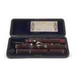 A 19th Century flute, probably cocuswood in original box stamped Rudall & Rose No 1 Tavistock Street