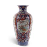 A very large Japanese porcelain vase of baluster form decorated in Imari style with panels of exotic