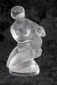 Lalique frosted glass model of a lady with goat, kneeling on rocky mound, on circular base with