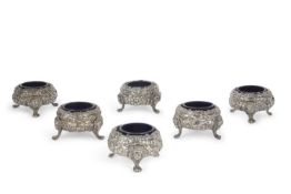 A set of six George III silver table salts of cauldron form elaborately decorated with masks,
