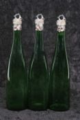 A rare set of three early Victorian silver mounted Bristol green glass wine bottles, the tapering