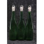 A rare set of three early Victorian silver mounted Bristol green glass wine bottles, the tapering