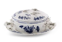 A Lowestoft porcelain butter tub, cover and matching stand with a blue printed floral design in