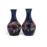 A pair of early 20th Century Moorcroft vases of baluster shape decorated with the Wisteria