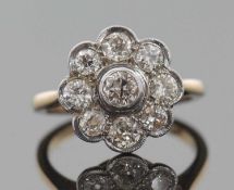 A diamond flowerhead cluster ring, comprised of round old cut diamonds, total estimated approx. 0.