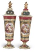 A pair of Vienna vases and covers with panels of classical ladies after Kaufmann surrounded by