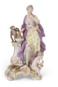A large 19th Century Meissen porcelain model of Flora standing by a plinth with basket of fruit with