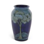 A tall Moorcroft vase c.1925 decorated with the Moonlit blue landscape pattern impressed factory