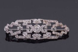 An Art Deco diamond brooch, set to centre with an old European cut diamond with further old cut,