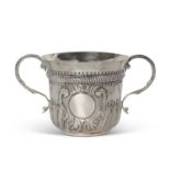 An early 20th Century copy of a George I loving cup, having two beaded scrolled handles, wrythen