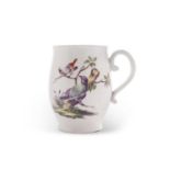 A small Derby porcelain mug bell shape with scroll handle, circa 1765, painted with birds on