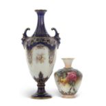 A Royal Worcester vase with mask handles painted with panels of fruit and flowers together with a