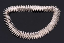 A silver necklace by Hans Hansen for Georg Jensen, comprised of triangular links with broad curved