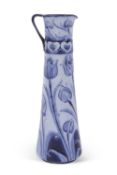 A Moorcroft Florian ware ewer with tube lined design in blue of tulips with Art Nouveau border to