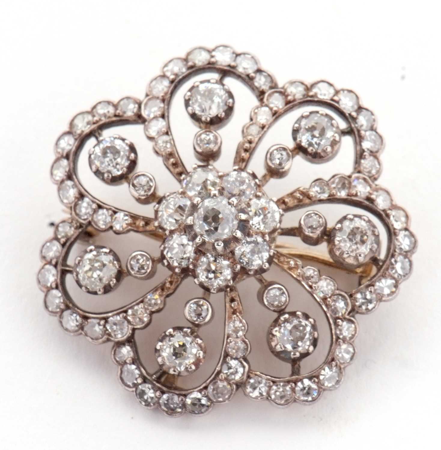 A late 19th/early 20th century diamond brooch, the central diamond flowerhead cluster, surrounded by - Image 2 of 8