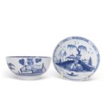 A Bow porcelain bowl with a Chinoiserie decoration in blue of fence and trees together with a Bow