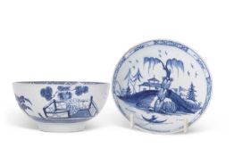 A Bow porcelain bowl with a Chinoiserie decoration in blue of fence and trees together with a Bow