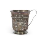 A George III silver mug with part fluted body and floral and scroll garland, framing a monogrammed