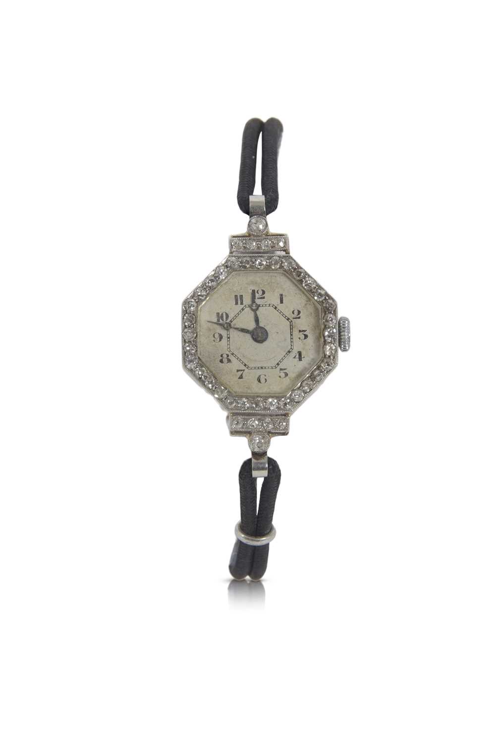 An Art Deco precious metal ladies wristwatch with old cut diamond bezel surround, it has a crown