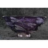 A large Studio Glass bowl by Julia Linstead, the purple coloured glass decorated with design of