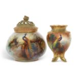 A Royal Worcester globular vase with pierced cover painted with a peacock signed by F J Bray