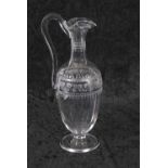 A late 18th/early 19th Century ewer of neo-classical form engraved with scrolling foliage around the