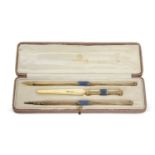 A George V silver gilt and enamel desk pen set comprising a propelling pencil, dip pen and a