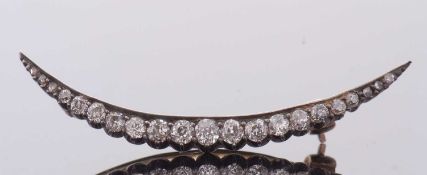 A Victorian diamond crescent brooch, set with graduated old cut and rose cut diamonds, total